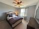 Cozy bedroom with soft carpet, a ceiling fan, and a charming window view at 9482 Kendrick Way, Arvada, CO 80007