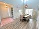 Elegant dining room featuring high ceilings, large table and decorative lighting at 9482 Kendrick Way, Arvada, CO 80007