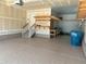 This garage features epoxy floors, wood shelves, and a stair case leading to a door at 9482 Kendrick Way, Arvada, CO 80007