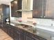 Gourmet kitchen featuring gas range, stainless hood, tile backsplash and granite countertops at 9482 Kendrick Way, Arvada, CO 80007