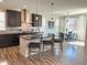 Beautiful kitchen featuring dark cabinets and stainless steel appliances, with a dining area in the background at 9482 Kendrick Way, Arvada, CO 80007