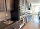 Well-equipped kitchen with stainless steel oven, dark cabinets, granite counters, and stylish backsplash at 9482 Kendrick Way, Arvada, CO 80007