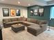 This living room features a sectional sofa, plush carpeting, and decorative wall art at 9482 Kendrick Way, Arvada, CO 80007