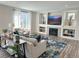 Bright living room featuring a fireplace, large window, and modern decor with an open floor plan at 9482 Kendrick Way, Arvada, CO 80007