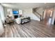Open-concept living room with fireplace, built-ins and staircase at 9482 Kendrick Way, Arvada, CO 80007
