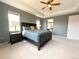 Comfortable main bedroom with ceiling fan, plush carpet, and view to the ensuite bathroom at 9482 Kendrick Way, Arvada, CO 80007