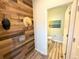 Stylish powder room featuring wood paneling and modern fixtures at 9482 Kendrick Way, Arvada, CO 80007
