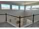 Bright upstairs landing showcasing scenic mountain views through transom windows at 9482 Kendrick Way, Arvada, CO 80007