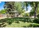 Enjoy a large private backyard featuring lots of mature trees and lush green grass at 6624 S Sycamore St, Littleton, CO 80120