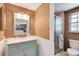 Stylish bathroom featuring a vanity with a mirror, tiled shower, and natural light at 6624 S Sycamore St, Littleton, CO 80120