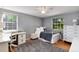 Bright bedroom with desk, windows, neutral colors, and wood floors offers versatility and charm at 6624 S Sycamore St, Littleton, CO 80120