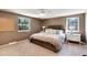 Relaxing bedroom featuring a plush bed, ample natural light, and side tables at 6624 S Sycamore St, Littleton, CO 80120