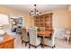 Formal dining room with an elegant chandelier, a wooden dining table with upholstered chairs, and a china cabinet at 6624 S Sycamore St, Littleton, CO 80120