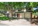 Side view of a well-maintained two-story home with a spacious driveway and an attached two-car garage at 6624 S Sycamore St, Littleton, CO 80120