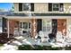 Inviting front porch with comfortable seating, colorful flowers, and a charming brick facade with black shutters at 6624 S Sycamore St, Littleton, CO 80120