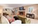 Comfortable living room with a brick fireplace and a view of the open kitchen and dining area at 6624 S Sycamore St, Littleton, CO 80120