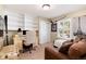 Functional office space with built-in shelves, a desk, and a cozy seating area at 6624 S Sycamore St, Littleton, CO 80120