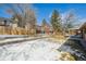 Backyard with a wooden fence and a small covered patio in the distance at 1843 S Pierson Ct, Lakewood, CO 80232