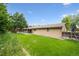 Exterior of home showcasing the large, well-manicured backyard and covered patio; perfect for outdoor entertaining at 1843 S Pierson Ct, Lakewood, CO 80232