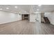 Finished basement with stone fireplace, stairs, and laundry room, offering ample space and amenities at 1843 S Pierson Ct, Lakewood, CO 80232