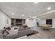 Finished basement with a gray sectional, pool table, fireplace, and wood-look flooring at 1843 S Pierson Ct, Lakewood, CO 80232