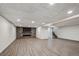 Spacious basement featuring a fireplace with stonework and wood-look flooring at 1843 S Pierson Ct, Lakewood, CO 80232