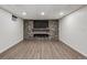 Basement with stone fireplace and wood look floors, perfect for a cozy Gathering space at 1843 S Pierson Ct, Lakewood, CO 80232