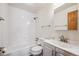 Clean bathroom featuring a shower-tub combo, tile, and ample light at 1843 S Pierson Ct, Lakewood, CO 80232