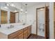 Bathroom with double sink vanity, marble counters, pendant lighting, and a separate toilet room at 1843 S Pierson Ct, Lakewood, CO 80232
