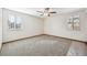 Spacious bedroom with neutral carpet, ceiling fan and windows bringing in natural light at 1843 S Pierson Ct, Lakewood, CO 80232