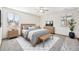 Staged bedroom with large bed, side tables, and bench, providing a cozy and inviting atmosphere at 1843 S Pierson Ct, Lakewood, CO 80232