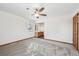 Empty bedroom with plush carpet, view of the bathroom, a window, neutral walls, and a ceiling fan at 1843 S Pierson Ct, Lakewood, CO 80232