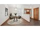 Cozy dining room with a stylish round table, hardwood floors, and a modern chandelier at 1843 S Pierson Ct, Lakewood, CO 80232