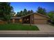 Charming single-Gathering home featuring a brick facade, manicured lawn, and attached two-car garage at 1843 S Pierson Ct, Lakewood, CO 80232