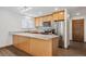 Kitchen with granite countertops, stainless steel appliances, and natural wood cabinets at 1843 S Pierson Ct, Lakewood, CO 80232