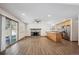 Bright, open living space featuring hardwood floors, fireplace and sliding glass doors leading to the patio at 1843 S Pierson Ct, Lakewood, CO 80232