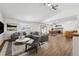 Cozy living room area with modern gray sofa, stylish decor, and an open view to the dining and kitchen area at 1843 S Pierson Ct, Lakewood, CO 80232