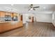 Open-concept living room and kitchen with wood floors, granite counters, and ample natural light at 1843 S Pierson Ct, Lakewood, CO 80232
