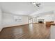 Large living area with hardwood floors, a fireplace and ceiling fans, adjacent to the kitchen at 1843 S Pierson Ct, Lakewood, CO 80232