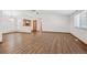 Spacious living room with hardwood floors, white walls, and large windows, ideal for entertaining at 1843 S Pierson Ct, Lakewood, CO 80232