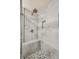 Modern walk-in shower with sleek gray tiling, bench seating, and recessed niche for toiletries at 1843 S Pierson Ct, Lakewood, CO 80232