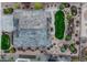 An aerial view of the home showcases a meticulously landscaped yard with mature trees and decorative rock gardens at 3242 Waterfront Dr, Monument, CO 80132