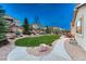 Beautifully landscaped backyard with decorative rock and concrete paths leading to a patio at 3242 Waterfront Dr, Monument, CO 80132