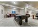 Basement game room features a pool table and built-in bookshelves, perfect for entertaining at 3242 Waterfront Dr, Monument, CO 80132