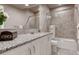 Modern bathroom with granite countertop, tiled shower, and vanity at 3242 Waterfront Dr, Monument, CO 80132