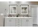 Bathroom featuring double sinks, granite countertops, tiled backsplash, and white cabinetry at 3242 Waterfront Dr, Monument, CO 80132