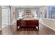 Spacious bedroom features a large bed, hardwood floors, and windows with plantation shutters at 3242 Waterfront Dr, Monument, CO 80132