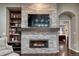 Cozy living room with a modern fireplace, built-in shelving, and a comfortable seating area at 3242 Waterfront Dr, Monument, CO 80132