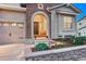 Close-up of front entrance with decorative stone, well lit portico, and a tidy garden bed at 3242 Waterfront Dr, Monument, CO 80132