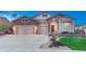 Beautiful front exterior with stone accents, three-car garage, concrete driveway and well-maintained lawn at 3242 Waterfront Dr, Monument, CO 80132